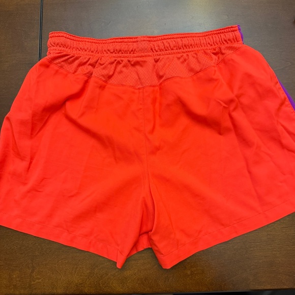 Nike Orange Shorts with purple side stripe accent. - Picture 2 of 3